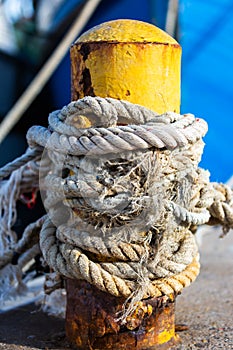 Rope tied around bright yellow pole