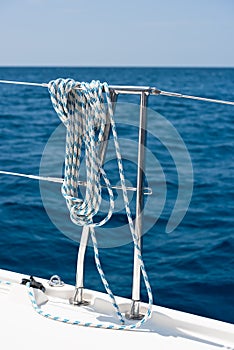 A rope tied around a lifeline on a yacht