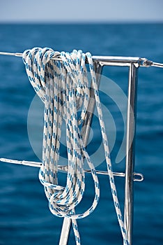 A rope tied around a lifeline on a yacht