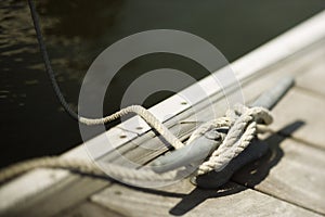 Rope tied to cleat on dock