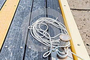 Rope wrapped around mooring cleat on pier