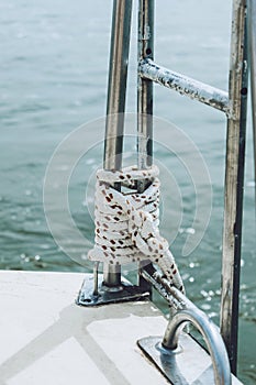 Rope on a yacht. Yacht rope cleat and sunlight. Sailboat winch and rope yacht detail. Yachting