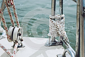 Rope on a yacht. Yacht rope cleat and sunlight. Sailboat winch and rope yacht detail. Yachting