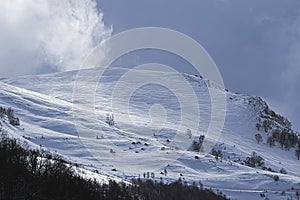 Roped party on snowy and windy crest