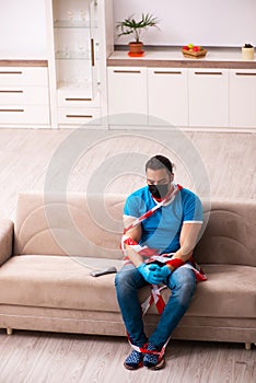 Roped young man being unhappy at home in quarantine concept