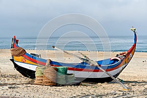 Ropes and colorful fishing boats on the sand