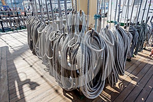 Ropes on a deck of a sailing ship. Equipment of sailing boat and ship`s exterior