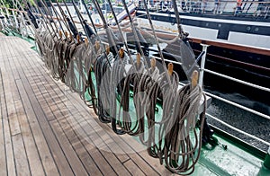 Ropes on a deck of a sailing ship. Equipment of sailing boat and ship`s exterior. Concept of travel, adventure and sea.