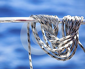 Ropes or mainsheets on the deck of sailboat hanging