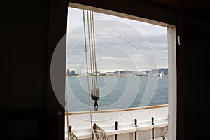 Ropes and pulley on a sailing boat against the skyline of Barcelona