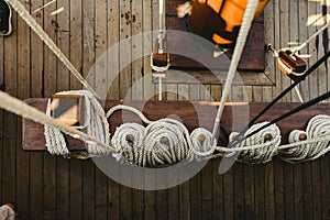 Ropes to hold the sails of an old sailboat rolled