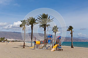 Roquetas de Mar beach wih palm trees Costa Almeria Spain La Romanilla