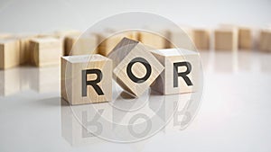 ROR - return on assets shot form on wooden block