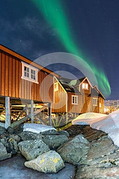 Rorbue norwegian fisherman house under green northern light