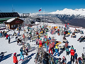 Rosa Khutor, Sochi / Russia - MARCH 06 2018: Skiers and snowboarders relax while sunbathing.