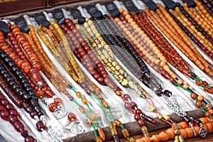 Rosaries made of amber stone. Amber rosaries on the seller`s counter