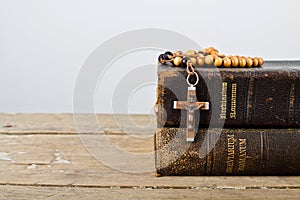 Rosary beads and books of Catholic Church liturgy