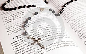 Rosary beads, cross and Bible