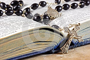 Rosary beads, cross and Bible