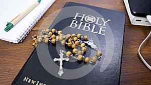 Rosary beads with cross crucifix on Holy Bible