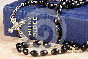 Rosary beads, cross and Bible