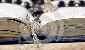 Rosary beads, cross and Bible