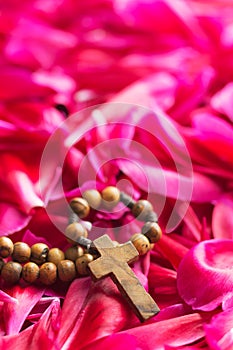 Rosary beads on flower background.