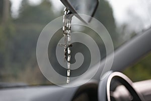 Rosary Beads Hanging In Car