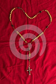 Rosary beads on red background photo