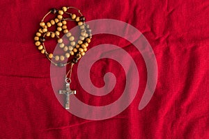 Rosary beads on red background photo