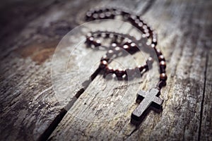Rosary beads and religious crucifix cross background