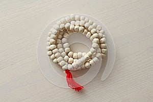 Rosary or beads from the sacred tree of Tulasi with a red tassel