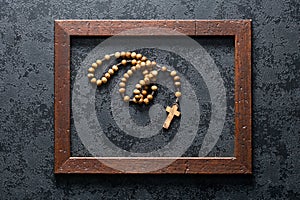 Rosary beads in wooden frame