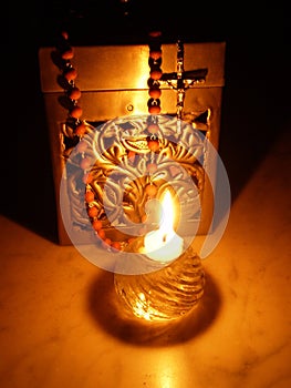 Rosary, box and a candle