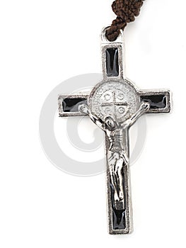 Rosary crucifix detail, cross isolated on white background.
