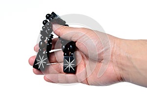 Rosary in hand on a white background isolated