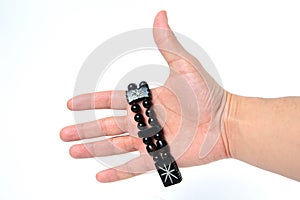 Rosary in hand on a white background isolated