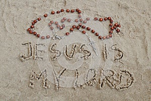 A rosary lying on the sand