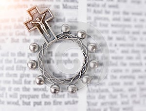 Rosary, open book or bible study for faith, studying religion or mindfulness with holy spiritual scripture. Christian