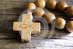 Rosary on wooden board with sign of fish