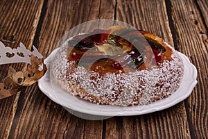 Rosca de reyes, king cake, glazed fruit, Provencal Galette des rois on a wooden table