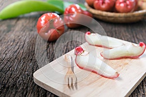 Rose apple on wood plate