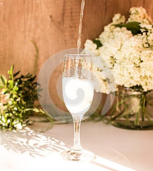 Rose blush wine in glasses. Bottle of rose wine with flowers on background. Prosecco