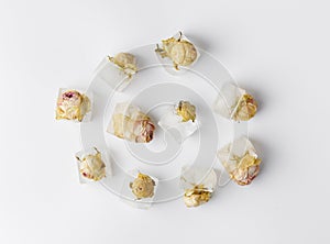 Rose buds in ice cubes on white isolated top view