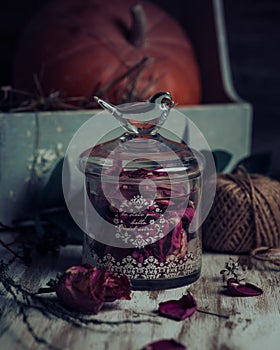 Rose buds tea, tea strainer and glass jar. Selective focus