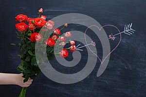 Rose on a chalkboard background, heart drawn in chalk