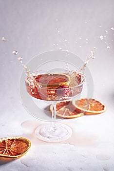 Rose champagne splashing on a light background