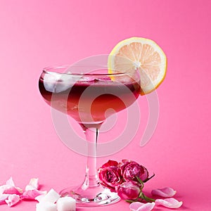 Rose cocktail in champagne glass on pink background