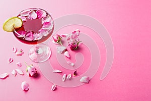 Rose cocktail in champagne glass on pink background