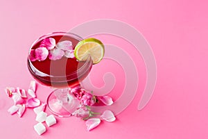 Rose cocktail in champagne glass on pink background